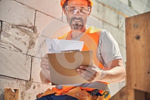 Man with a clipboard and a document