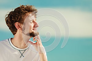 Man with closed eyes relaxing breathing fresh air.
