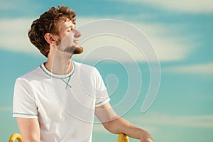 Man with closed eyes relaxing breathing fresh air.