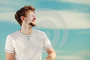 Man with closed eyes relaxing breathing fresh air. photo