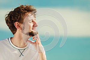 Man with closed eyes relaxing breathing fresh air. photo