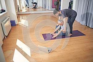 Man with closed eyes sitting on the mat