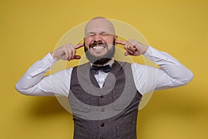 Man closing ears with fingers not wanting to hear something photo