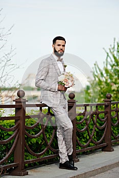 Man Clothed Stylish Suit Holding Bouquet of Flower