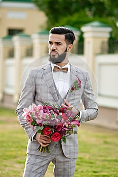 Man Clothed Stylish Suit Holding Bouquet of Flower