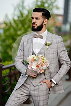 Man Clothed Stylish Suit Holding Bouquet of Flower photo
