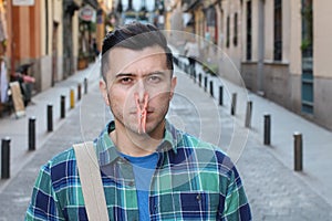 Man with clothespin blocking his nostrils