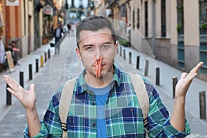 Man with clothespin blocking his nostrils