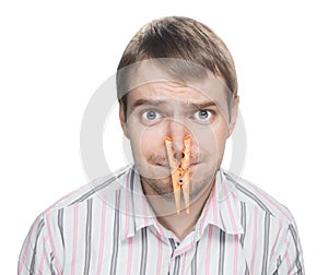 Man with clothespin on his nose.