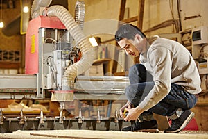 Man at the CNC machine. Tool with computer numerical control.