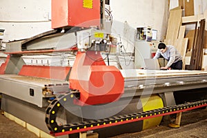 Man at the CNC machine. Tool with computer numerical control.