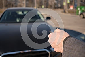 The man in the coat sent the keychain to the car to turn on the alarm