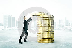 Man with coins tower concept