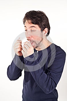 Man with cold holding tissue