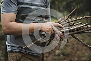 Man collecting dry twigs for bonfire