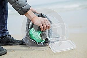 Man collecting garbage on the beach