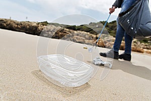 Man collecting garbage on the beach