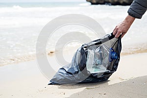 Man collecting garbage on the beach