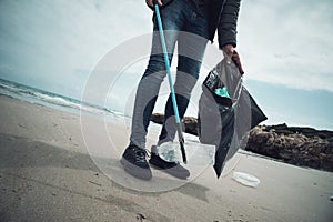 Man collecting garbage on the beach