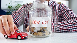 Man collecting money for buying new car. Concept of finance, economy growth and bank savings