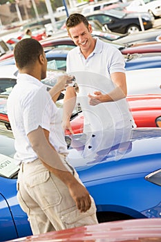 Man collecting new car photo