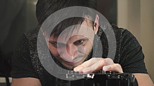 A man collects components for a system case, a computer. Close-up