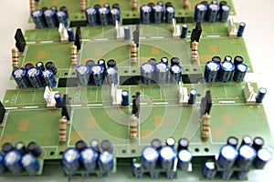 A man collects a printed circuit board. The worker solders the radio components and assembles the finished device