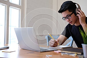 Man college student  studying learning lesson with computer online taking note