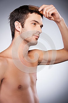 Man combing hair.