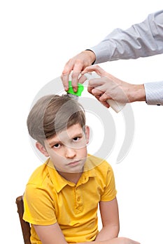 Man combs out nits at the young boy
