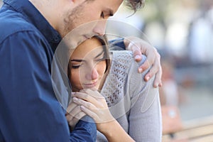 Man comforting his sad mourning friend