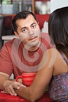 Man Comforts Friend in Cafe