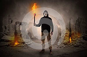 Man coming with burning flambeau at a catastrophe scene concept