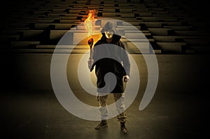 Man coming with burning flambeau from the maze concept