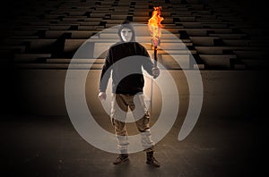 Man coming with burning flambeau from the maze concept