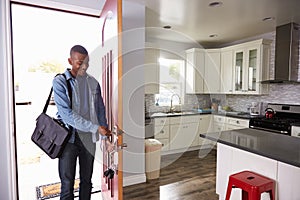 Man Coming Home From Work And Opening Door Of Apartment