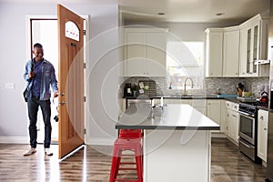 Man Coming Home From Work And Opening Door Of Apartment