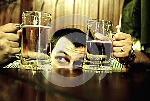 Man comparing beer mugs