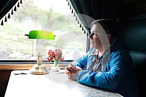 Man in compartment of retro train carriage