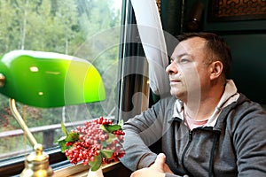 Man in compartment of vintage train carriage