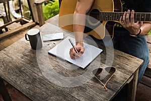 Man compose song and play guitar