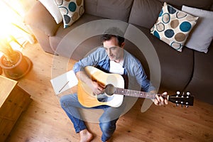 Man composing for guitar sitting