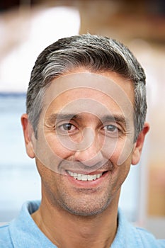 Man At Computer Terminal In Distribution Warehouse