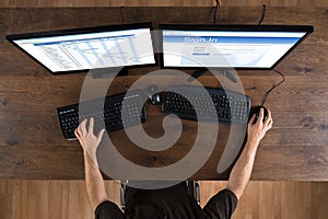 Man With Computers Showing Gantt Diagram And Signin App