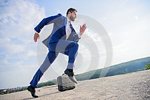 Man concentrated focused on business achievement. Businessman formal suit run outdoors blue sky background. Business as photo