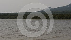 Man is concentrating and swim in a boat