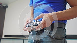 Man concept playing gamepad hands video console on tv. Gamer play game with gamepad controller. Hand hold new joystick