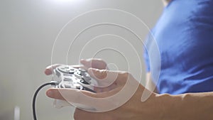 Man concept playing gamepad hands video console on tv. Gamer play game with gamepad controller. Hand hold new joystick