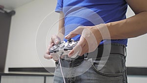 Man concept playing gamepad hands video console on tv. Gamer play game with gamepad controller. Hand hold new joystick