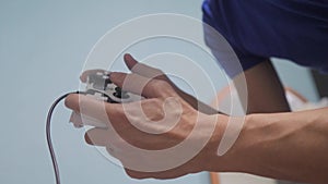 Man concept playing gamepad hands video console on tv. Gamer play game with gamepad controller. Hand hold new joystick